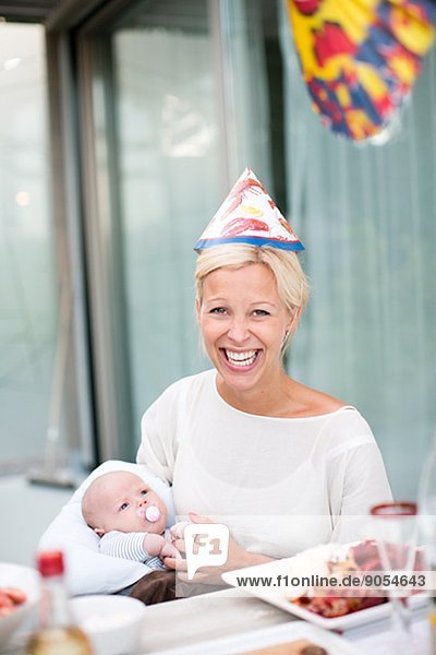 Smiling woman with baby at crayfish party  Stockholm  Sweden