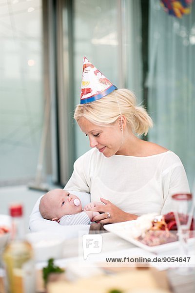 Smiling woman with baby at crayfish party  Stockholm  Sweden