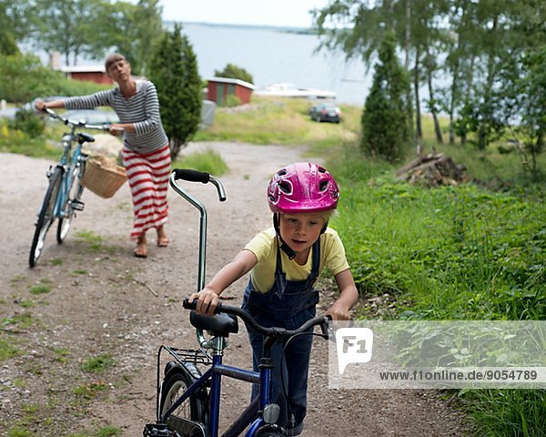 Boy with mother cycling  Blekinge  Sweden
