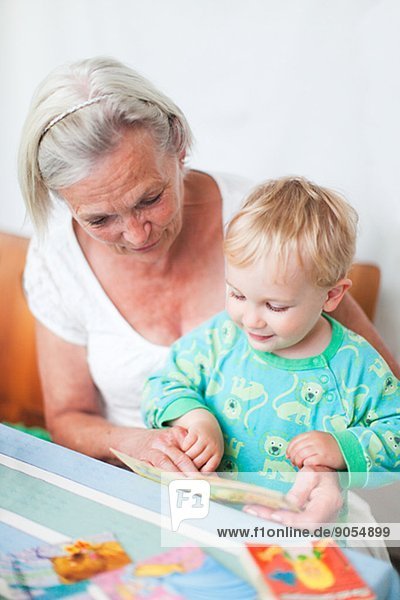 Grandmother with grandson reading greeting cards  Sweden