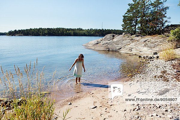 Woman wading in water  Sweden