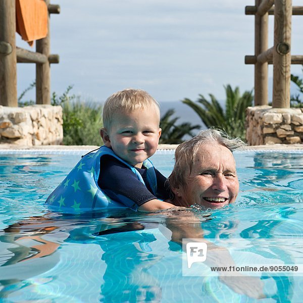 Grandmother swimming with grandson  Sicily  Italy