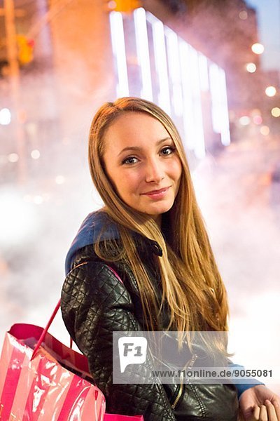 Teenage girl with shopping bags  New York City  USA