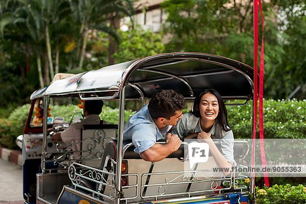 Smiling friends in rickshaw  Thailand
