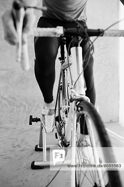 Mid adult man indoor cycling  studio shot