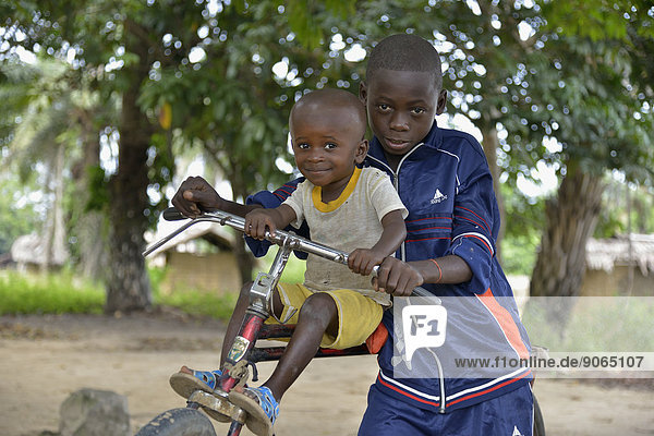 Two children with a bicycle  Nkala  Bandundu Province  Democratic Republic of the Congo