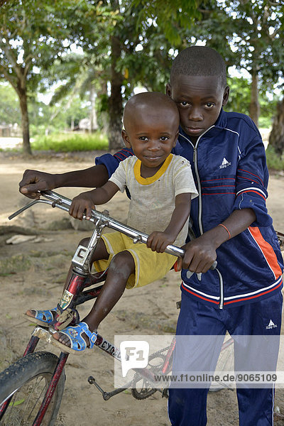 Two children with a bicycle,  Nkala,  Bandundu Province,  Democratic Republic of the Congo