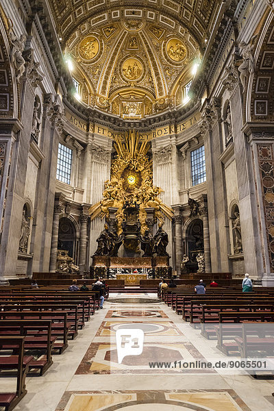 Worshippers in the choir in front of the Cathedra Petri by Bernini  St. Peter's Basilica  Vatican City  Vatican  Rome  Lazio  Italy