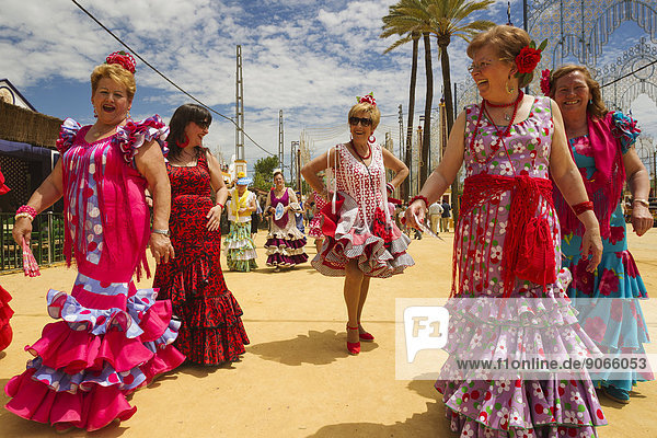 Women wearing gypsy dresses at the Feria del Caballo  Jerez de la Frontera  Cádiz province  Andalusia  Spain
