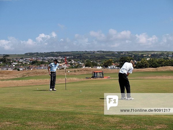 Two teenage boys playing golf  Bude  Cornwall