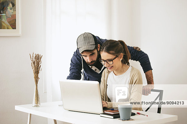 Young couple working at modern home office