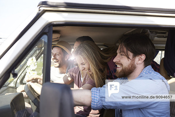Happy friends in minivan