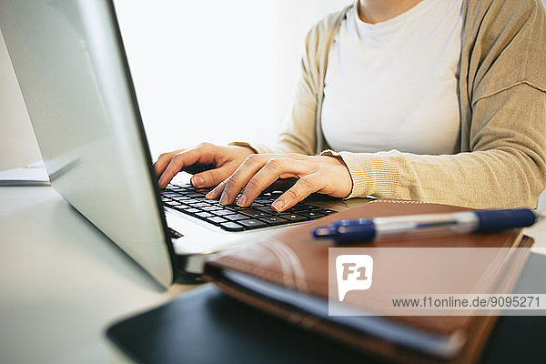 Woman working at modern home office  partial view
