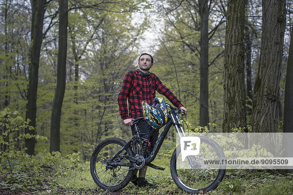 Germany  Lower Saxony  Deister  Bike Freeride in forest  Young man with moutain bike