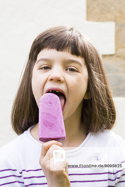 Portrait of little girl with yoghurt blueberry ice lolly