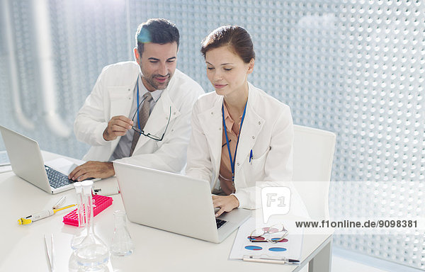 Doctors working at laptop