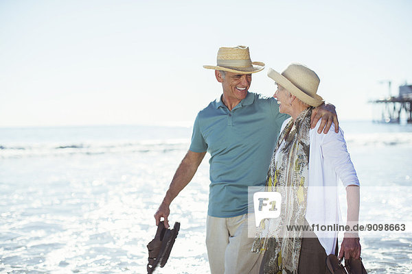 Senior couple walking on beach