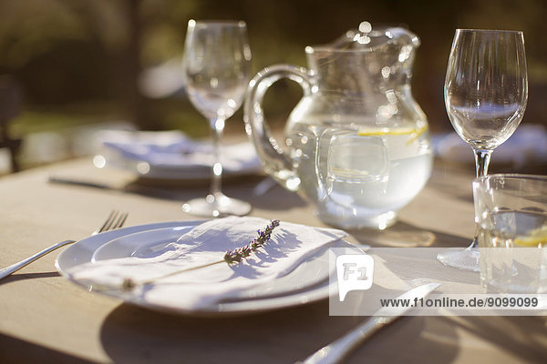 Lavender sprig on plate on sunny patio table