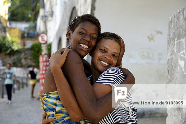 Former street child  girl  15  hugging her mother  Lapa district  Rio de Janeiro  Rio de Janeiro State  Brazil