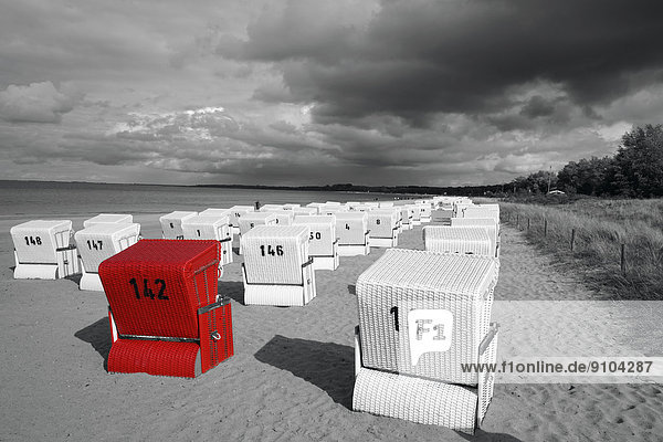 Beach with beach chairs  one red highlighted beach chair  Boltenhagen  Mecklenburg-Western Pomerania  Germany