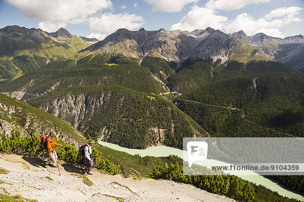 Hikers descending from Mt Murter into the Spöl Valley  Val dal Spöl  Swiss National Park  Graubünden  Switzerland
