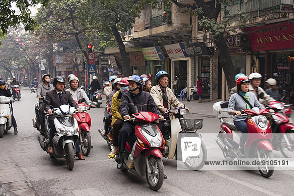 Street scene  moped riders on mopeds  Hanoi  North Vietnam  Vietnam