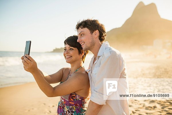 Young couple self-photographing  Ipanema Beach  Rio  Brazil