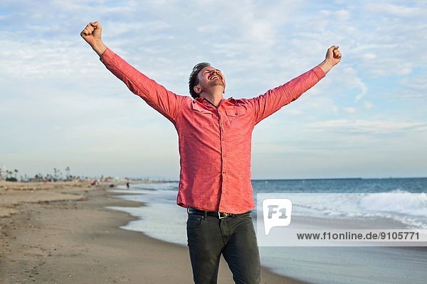 Junger Mann feiert am Strand  Long Beach  Kalifornien  USA