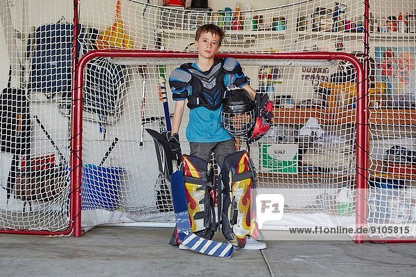 Boy in hockey goal wearing protective sportswear