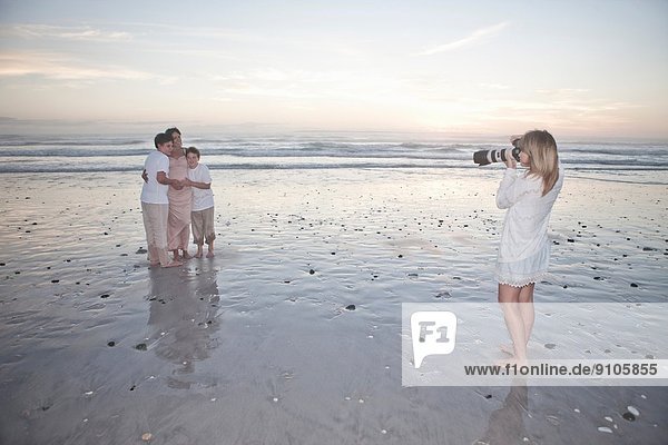 Photographer taking family portrait on beach  Cape Town  South Africa