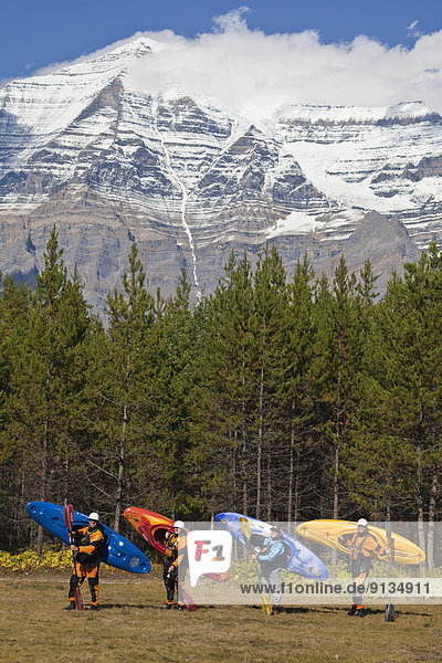 A group of kayakers pose for a photo after kayaking the Fraser River  Mt Robson Provinical Park  BC
