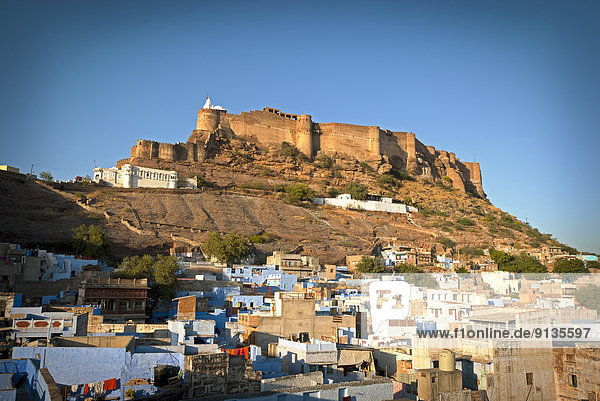 Mehrangarh Fort at sunset sits above the 'Blue City' Jodhpur  Rajasthan State India