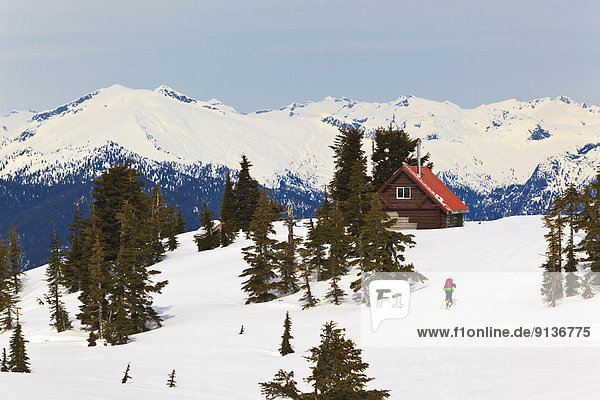 A skier ascends the trail to Mt. Steele cabin in Tetrahedron Provincial Park on the Sunshine Coast of British Columbia Canada.