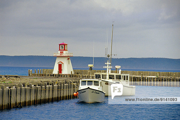 Lighthouse  wharf and boats  Belliveau Cove  Nova Scotia  Canada