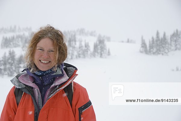 Woman smiling in snowy mountains Canmore Alberta Canada
