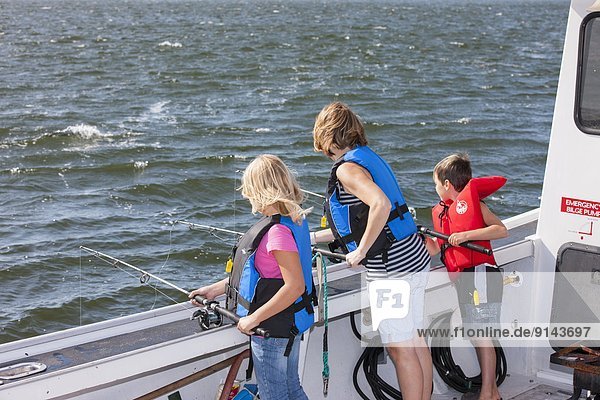 mother  son and daughter deep-sea fishing  Northport  Prince Edward Island  Canada