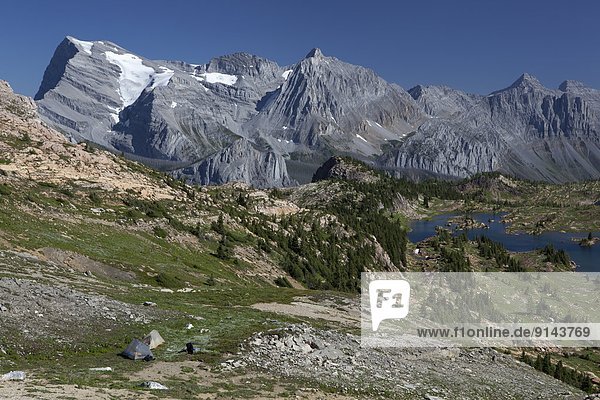 Tents at the pass above Lower Limestone Lakes Basin  Mount Abruzzi  Mount Lancaster  Mount Marconi  Mount Minton  Height of the Rockies Provincial Park  British Columbia  Canada
