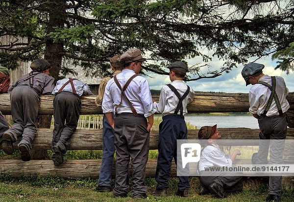 Boys dressed in old fashioned clothing at King's Landing  New Brunswick  Canada