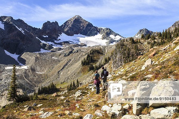 Male and female hikers on the trail at Whitewater Canyon  Goat Range Provincial Park  British Columbia.