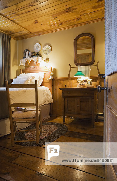 Guest room inside an old Canadiana residential log home  Quebec  Canada. This image is property released. PR0145