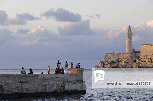 Fishing the harbor  Morro Castle  beyond  a picturesque fortress guarding the entrance to Havana bay  Havana  Cuba