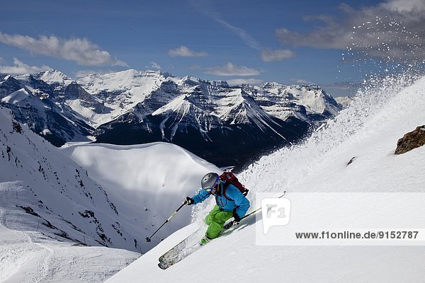 Young male skier skiing untracked slope at Lake Louise Ski Resort  Alberta  Canada.