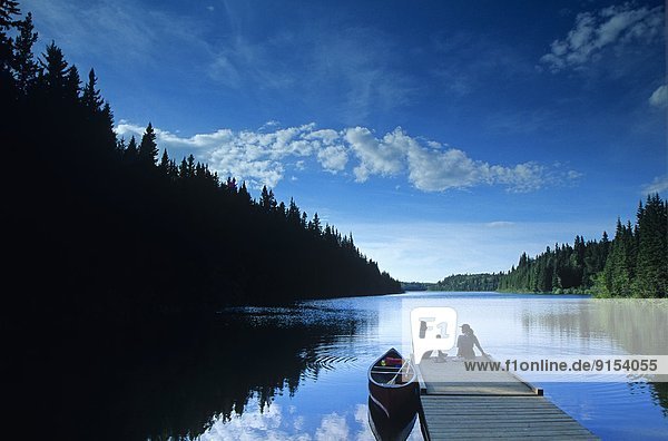 couple relaxing after canoeing   Duck Mountain Provincial Park  Manitoba  Canada