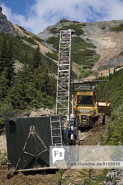 Bulldozer moving diamond drilling rig  Astlais mountain  BC