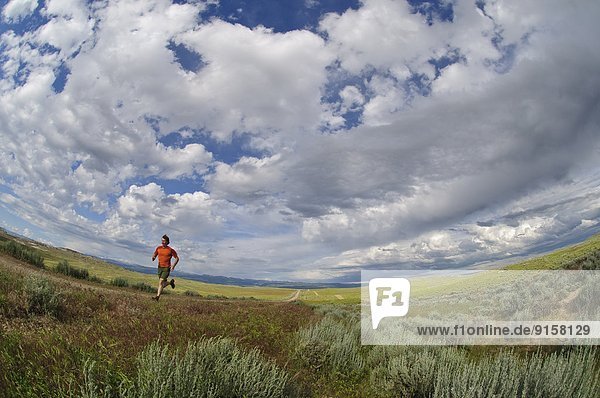 Man trail running near Ten Sleep  Wyoming. USA