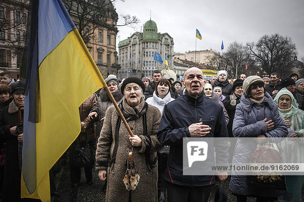 Singing the national anthem  mourning ceremony for victims of the Euromaidan in Kiev  Lviv  Western Ukraine  Ukraine