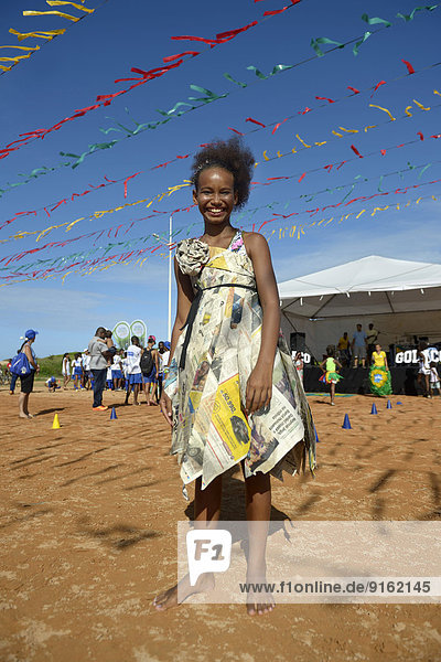 Girl presenting a dress made of recycled newspapers at a fashion show of a social project  Salvador da Bahia  Bahia  Brazil