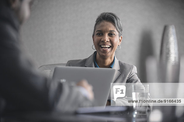 Businesswoman laughing in meeting