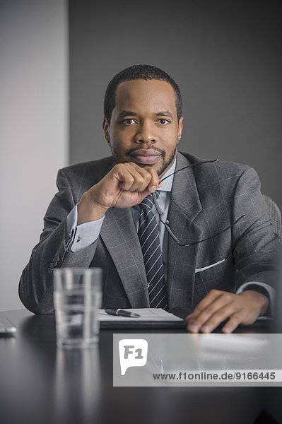 Mixed race businessman sitting in meeting