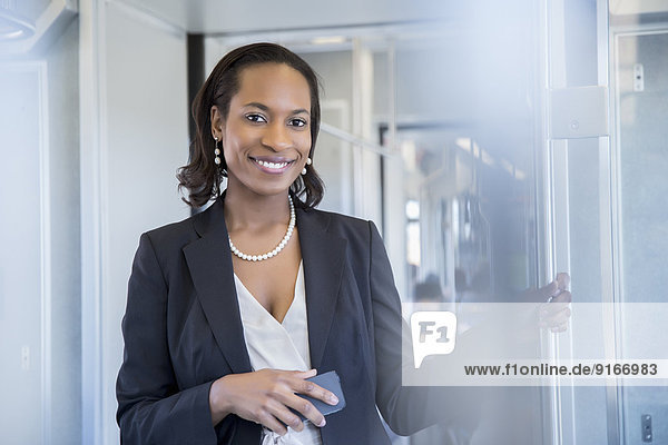 Black businesswoman smiling on train